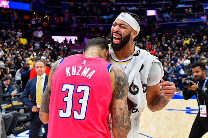 Los Angeles Lakers forward Anthony Davis reacts with Washington Wizards forward Kyle Kuzma after the game at Capital One Arena.